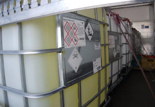 An IBC with chemical liquid and hazardous goods labelling secured on a euro.COURIER truck.