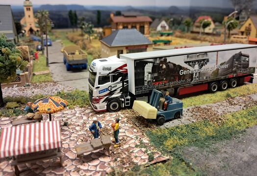 Herpa model truck from ECL on a model railway layout delivering urgent goods.