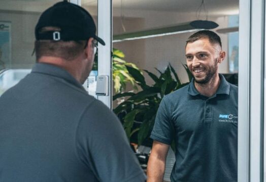 Two employees talk to each other in the company building